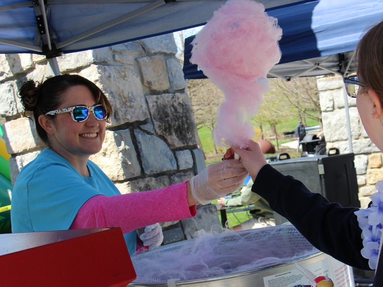 Autumn Fritz, Assistant Director, Community Development, Student Affairs handing out cotton candy during Spring Week